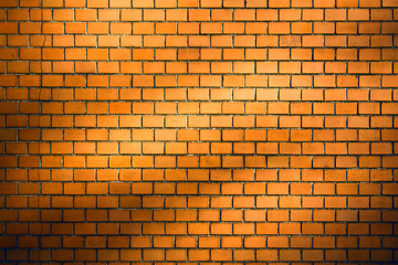 Fototapeta na wymiar orange brick wall background with natural shadow vignette