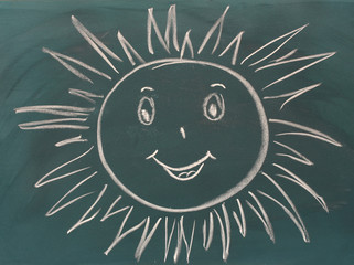 Blackboard with drawing smiling sun closeup