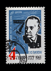 Eugen Paton, bridge over Dnieper river in Kiev, Ukraine. USSR, circa CIRCA 1963. vintage post stamp isolated on black background.