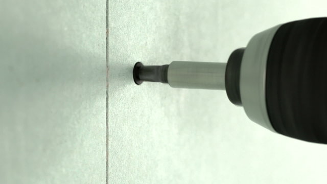 Driving a screw into drywall