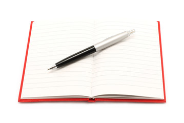 Notepad with ball pen on a white background