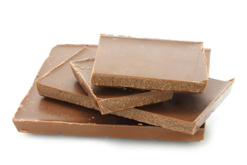 Pieces of milk chocolate on a white background