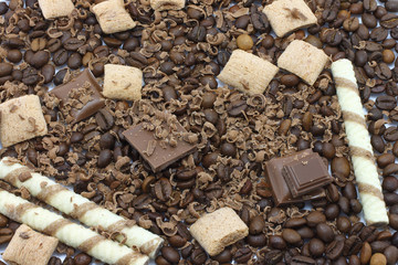 Chocolate pieces and coffee beans for background