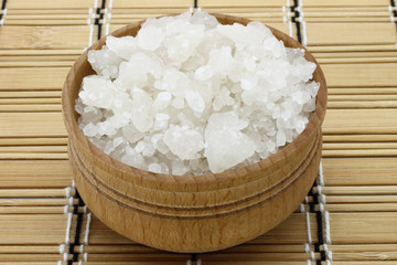 Sea salt in a wooden tableware close-up