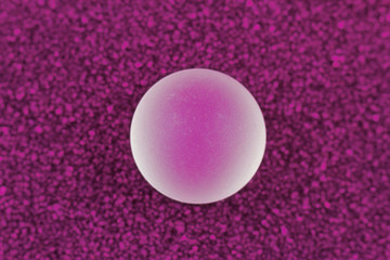 Polished glass ball on a soft purple carpet