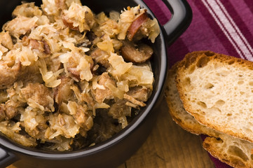 traditional polish sauerkraut (bigos) with mushrooms and plums f
