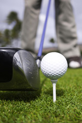 Close up of golf ball on tee and driver set up