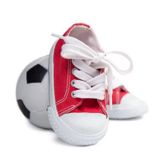 Children's sneakers and soccer ball