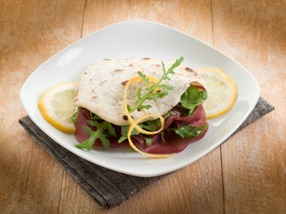 chapati sandwich  with bresaola and arugula salad