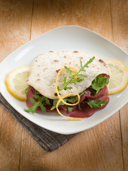 chapati sandwich  with bresaola and arugula salad