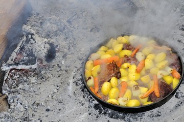 Pork with potatoes and carrot roasted in metal plate