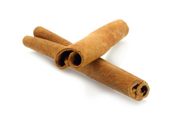 Two cinnamon sticks on white background