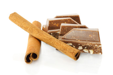 Chocolate and cinnamon sticks on white background