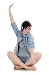 Obraz premium Girl listens to music through ear-phones