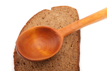 Wooden spoon and a slice of bread