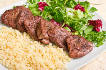 Tenderloin steaks in wine sauce with cadamon and kuskus groats