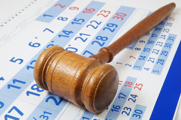 Wooden gavel on paper calendar