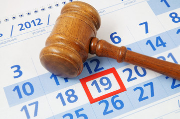 Wooden gavel on paper calendar