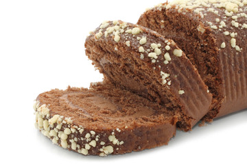 Chocolate Swiss roll closeup on a white background