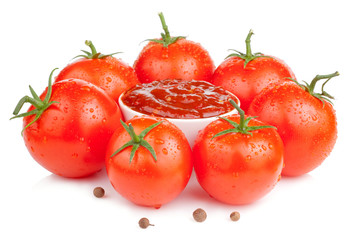 Bowl with fresh ketchup and six wet juicy ripe tomatoes isolated