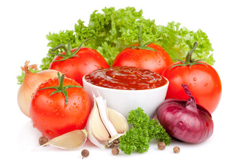 Fresh ketchup and a set of vegetables: tomatoes, onions, garlic,