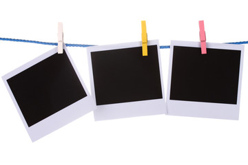 Photo paper hanging on the clothesline isolated on white