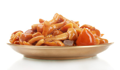 Marinated mushrooms in brown saucer isolated on white