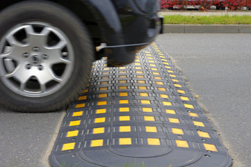 Speed bump on a road when and car