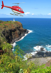 chopper flying above hawaiian bay