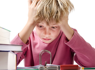 desperate boy doing is homework - isolated on white background