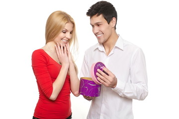 young romantic man presenting gift in boxe to girl