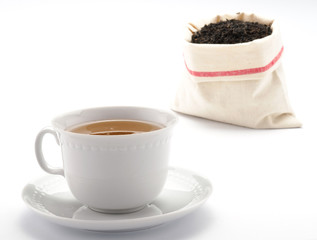 Tè nella tazza e sacchetto di tè in foglie
