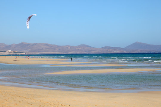 Kitesurfing on the beach of Fuerteventura, Spain