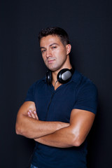 man standing with his arms crossed and headphones