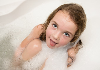 Little girl in soap foam