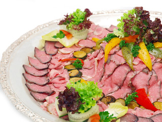 roast beef on silver platter