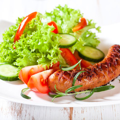Grilled sausage with vegetable salad