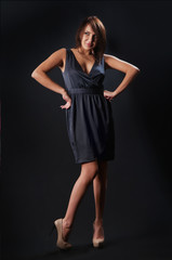Fototapeta premium brunette girl posing in studio on dark background