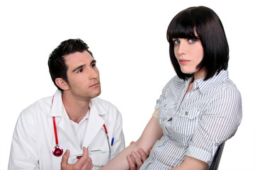 Doctor kneeling by a female patient