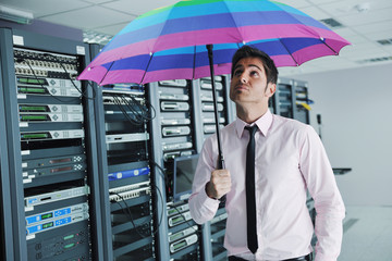 businessman hold umbrella in server room