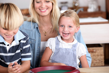 Young woman and children playing dices