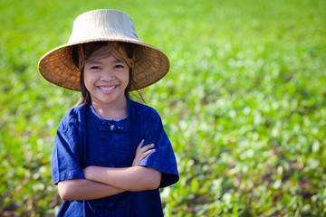 Little smiling girl farmer on green fields, Outdoor portrait