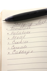 Shoping list and pen isolated on white