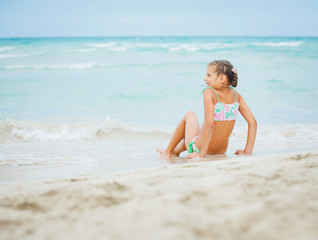 Fototapeta na wymiar Adorable happy little girl on beach vacation