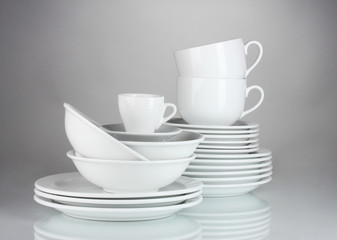 Fototapeta premium empty bowls, plates and cups on gray background