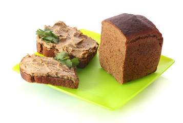 Fresh pate on bread on green plate isolated on white