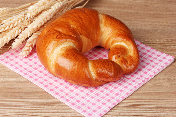 Bagel on napkin on wooden table
