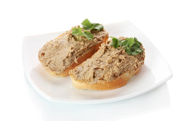 Fresh pate on bread on white plate isolated on white