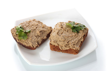Fresh pate on bread on white plate isolated on white