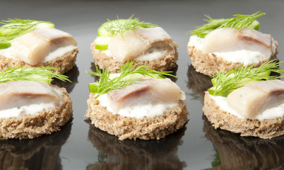 sandwiches with herring, cucumber and dill